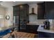 Stylish kitchen featuring stainless steel appliances, dark cabinets, and a cozy breakfast bar with counter seating at 16322 E Fairview St, Gilbert, AZ 85295
