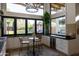 Cozy kitchen area with modern appliances, a small dining table, and convenient wine storage at 16322 E Fairview St, Gilbert, AZ 85295