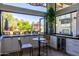 Charming kitchen nook with a small table, a view of the backyard, and a convenient wine refrigerator at 16322 E Fairview St, Gilbert, AZ 85295