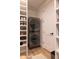 Modern laundry room featuring gray stackable washer and dryer set with easy access door and ample shelving at 16322 E Fairview St, Gilbert, AZ 85295