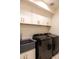 Bright laundry room with black washer/dryer and a deep utility sink at 16322 E Fairview St, Gilbert, AZ 85295