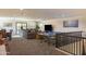 Large, carpeted living room with sectional sofa, ping pong table, and adjacent dining area at 16322 E Fairview St, Gilbert, AZ 85295
