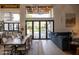 Open-concept dining and living areas, featuring a large table, comfortable sofa, and backyard views at 16322 E Fairview St, Gilbert, AZ 85295