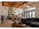 Open-concept living space featuring exposed wooden beams, floor-to-ceiling windows and ample room for entertaining at 16322 E Fairview St, Gilbert, AZ 85295