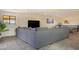 Spacious carpeted living area featuring a sectional sofa and ping pong table at 16322 E Fairview St, Gilbert, AZ 85295