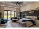 Cozy main bedroom with a sitting area, coffered ceiling, and natural light at 16322 E Fairview St, Gilbert, AZ 85295