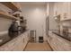 Walk-in pantry with granite countertops, white cabinetry, and stainless steel appliances at 16322 E Fairview St, Gilbert, AZ 85295