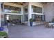 Expansive patio area with seating and a view of the interior through large folding glass doors and windows at 16322 E Fairview St, Gilbert, AZ 85295