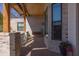 Covered porch featuring swing, stone columns, and wood ceiling showcasing a tranquil spot for relaxation and style at 16322 E Fairview St, Gilbert, AZ 85295