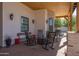 Inviting covered porch with rocking chairs, wooden ceiling, and stone columns offers a cozy outdoor space at 16322 E Fairview St, Gilbert, AZ 85295