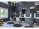 Chic hair salon featuring dark walls, stylish chairs, individual mirrors, and elegant lighting fixtures at 16322 E Fairview St, Gilbert, AZ 85295