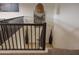 Staircase with carpet on landing and wood on stairs, featuring dark railing at 16322 E Fairview St, Gilbert, AZ 85295