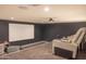 Home theater with tiered seating and a large projection screen at 16322 E Fairview St, Gilbert, AZ 85295