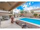 Backyard pool with seating areas and a patio with ceiling fans at 16424 W Cottonwood St, Surprise, AZ 85388