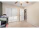 Bright bedroom with neutral carpet, a ceiling fan, and large closets at 16424 W Cottonwood St, Surprise, AZ 85388