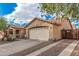 Rear and side view of house featuring an extra long driveway leading to the attached two car garage at 16424 W Cottonwood St, Surprise, AZ 85388