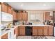 Well-lit kitchen showcasing ample counter space and wood cabinets at 16424 W Cottonwood St, Surprise, AZ 85388