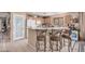 Inviting kitchen featuring a breakfast bar with seating and a pantry door at 16424 W Cottonwood St, Surprise, AZ 85388