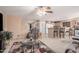 Open living room featuring neutral walls, ceiling fan, bar seating area, and access to the kitchen at 16424 W Cottonwood St, Surprise, AZ 85388