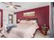 Comfortable primary bedroom with a ceiling fan and an ensuite bathroom access at 16424 W Cottonwood St, Surprise, AZ 85388