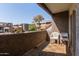 Enjoy the lovely community views from the condo's balcony, furnished with a pair of chairs at 1645 W Baseline W Rd # 2032, Mesa, AZ 85202