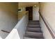 Condo entryway featuring access stairs, desert tones and a secure, decorative metal door at 1645 W Baseline W Rd # 2032, Mesa, AZ 85202