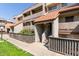 Inviting condo exterior with well-maintained landscaping, warm desert tones, and a classic tile roof at 1645 W Baseline W Rd # 2032, Mesa, AZ 85202
