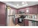 Well-equipped kitchen with granite countertops, stainless steel appliances, and ample cabinet space at 1645 W Baseline W Rd # 2032, Mesa, AZ 85202