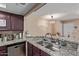 Beautiful kitchen featuring granite countertops, stainless steel appliances, and dark wood cabinets at 1645 W Baseline W Rd # 2032, Mesa, AZ 85202