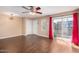Bright living room with hardwood floors, ceiling fan, and sliding glass doors at 1645 W Baseline W Rd # 2032, Mesa, AZ 85202