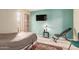 Cozy bedroom with exercise equipment, TV, and laminate wood flooring at 1658 N Sierra Vista Dr, Tempe, AZ 85288