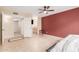 Well-lit bedroom with tile flooring, neutral walls, and a ceiling fan at 1658 N Sierra Vista Dr, Tempe, AZ 85288