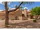 Tan single-story home with a red tile roof, desert landscaping, and mature trees, and blue skies with clouds at 1658 N Sierra Vista Dr, Tempe, AZ 85288