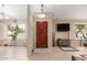Open foyer with tile floors, a wooden front door, and two windows with shuttered blinds at 1658 N Sierra Vista Dr, Tempe, AZ 85288