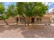 Tan single-story home with desert landscaping and mature trees, and three doors visible in the front at 1658 N Sierra Vista Dr, Tempe, AZ 85288
