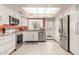Modern kitchen with white cabinets, stainless steel appliances, and a bright skylight at 1658 N Sierra Vista Dr, Tempe, AZ 85288