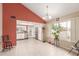 Bright kitchen with stainless steel appliances, a chandelier, tile floors, and a sunny window at 1658 N Sierra Vista Dr, Tempe, AZ 85288