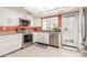Well-lit kitchen featuring stainless steel appliances and a view to the backyard at 1658 N Sierra Vista Dr, Tempe, AZ 85288