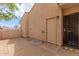 View of a private patio with brick pavers, an exterior door, and stucco walls at 1658 N Sierra Vista Dr, Tempe, AZ 85288