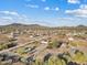 Aerial view of a neighborhood with houses nestled among desert landscape at 16643 W Quail Run Rd, Surprise, AZ 85378