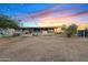 Expansive backyard featuring string lights and a cozy seating area at 16643 W Quail Run Rd, Surprise, AZ 85378