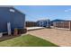 View of backyard with storage building, dog kennel, and artificial turf at 16643 W Quail Run Rd, Surprise, AZ 85378