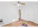 A clean and bright bedroom features wood-look floors and a modern ceiling fan at 16643 W Quail Run Rd, Surprise, AZ 85378