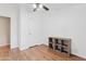 This bedroom offers wood-look floors, a ceiling fan, and a built-in bookshelf at 16643 W Quail Run Rd, Surprise, AZ 85378