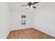 This bright bedroom features laminate wood flooring, a ceiling fan, and neutral paint at 16643 W Quail Run Rd, Surprise, AZ 85378