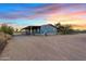 Charming single-story home with a covered porch and desert landscaping at 16643 W Quail Run Rd, Surprise, AZ 85378