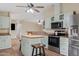 Well-equipped kitchen with stainless steel appliances and a center island featuring a wood countertop and stool seating at 16643 W Quail Run Rd, Surprise, AZ 85378