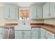 Farmhouse sink with stainless steel faucet with plenty of cabinet space at 16643 W Quail Run Rd, Surprise, AZ 85378