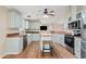 Well-equipped kitchen with stainless steel appliances and a center island featuring a wood countertop and stool seating at 16643 W Quail Run Rd, Surprise, AZ 85378
