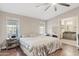 Cozy main bedroom with ensuite bathroom, wood floors and neutral decor at 16643 W Quail Run Rd, Surprise, AZ 85378